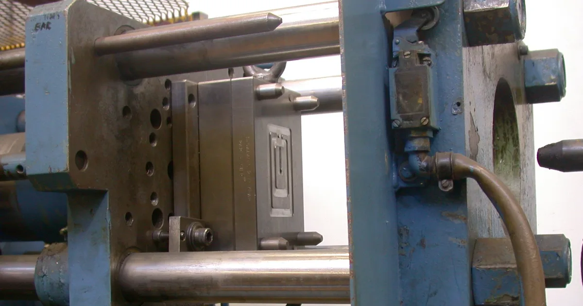 Clamping unit of an injection moulding machine with a die half bolted to the moving platen, between the tie bars and the fixed platen